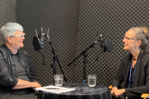 two persons in a podcast studio